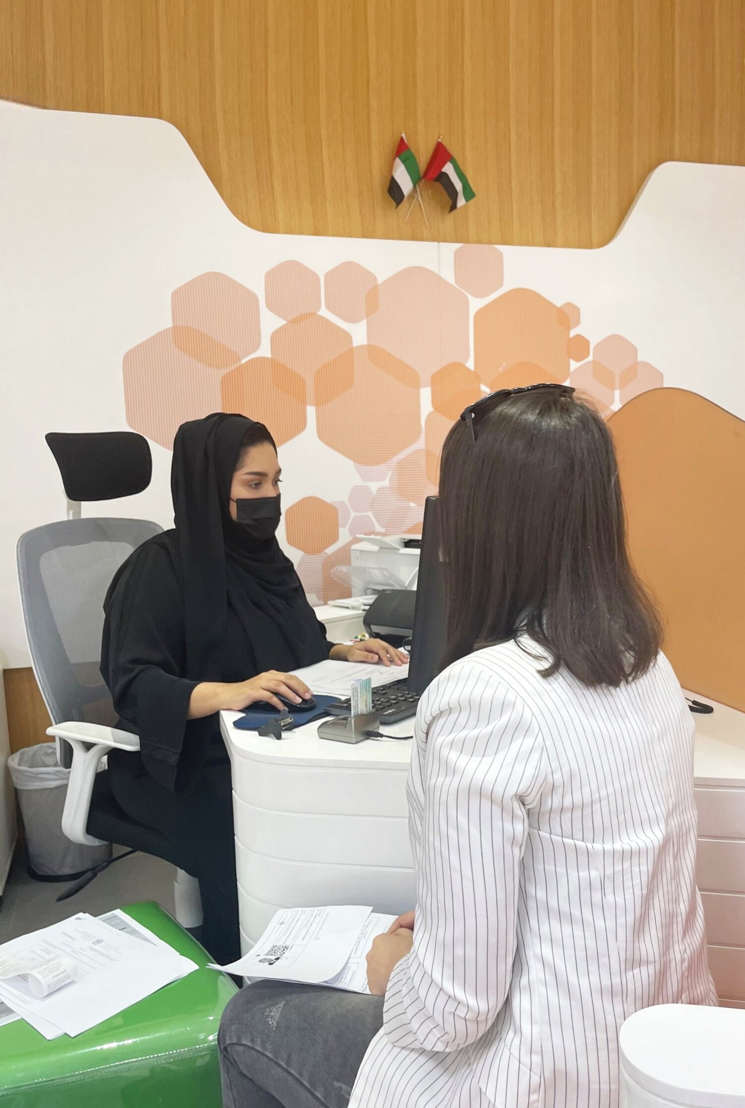 a arabian women in tawjeeh center doing government service for a lady